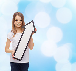 Image showing smiling little girl with blank arrow pointing up