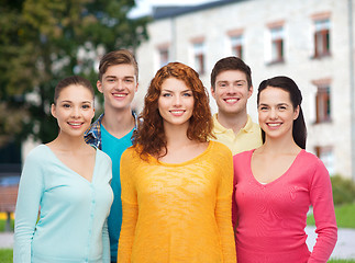 Image showing group of smiling teenagers over campus background