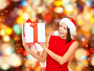 Image showing smiling woman in red dress with gift box