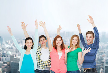 Image showing group of smiling students waving hands