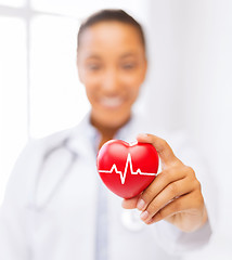 Image showing female doctor holding red heart with ecg line