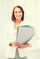 Image showing businesswoman with folders in office