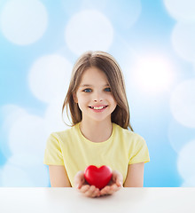 Image showing beautiful little girl sitting at table