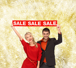 Image showing smiling couple with red sale sign