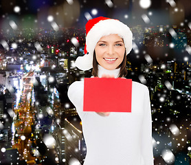 Image showing woman in santa helper hat with blank red card