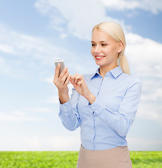 Image showing young smiling businesswoman with smartphone