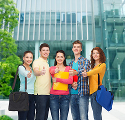 Image showing group of smiling teenagers showing thumbs up