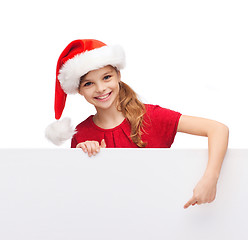 Image showing child in santa helper hat with blank white board