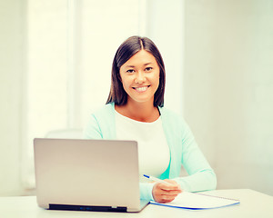 Image showing asian businesswoman with laptop and documents