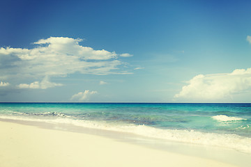 Image showing blue sea or ocean, white sand and sky with clouds