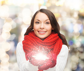 Image showing smiling woman in winter clothes with snowflake