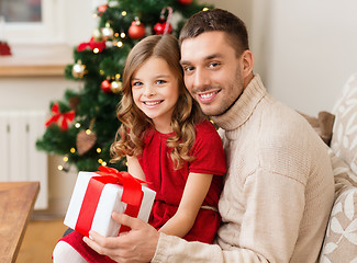 Image showing smiling father and daughter holding gift box