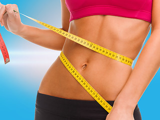 Image showing close up of trained belly with measuring tape