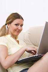 Image showing young pretty woman and laptop computer