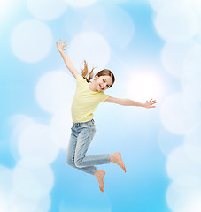 Image showing smiling little girl jumping