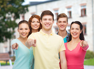 Image showing group of smiling teenagers over campus background