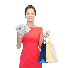 Image showing smiling elegant woman in dress with shopping bags