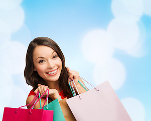 Image showing smiling young woman with shopping bags