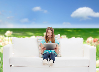 Image showing little girl sitting on sofa with tablet pc