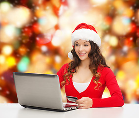 Image showing smiling woman with credit card and laptop