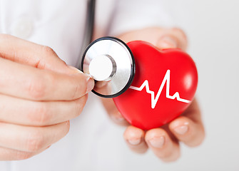 Image showing doctor hands holding red heart and stethoscope