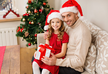 Image showing smiling father and daughter holding gift box