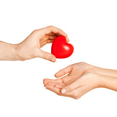 Image showing man hand giving red heart to woman