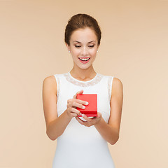 Image showing smiling woman holding red gift box