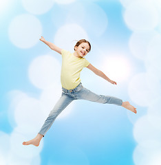 Image showing smiling little girl jumping