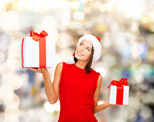 Image showing smiling woman in red dress with gift box