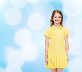 Image showing smiling little girl in yellow dress