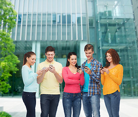 Image showing group of smiling teenagers with smartphones