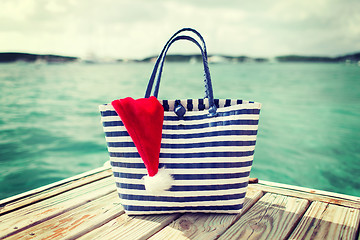 Image showing close up of beach bag and santa helper hat