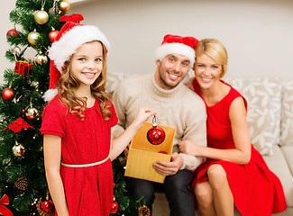 Image showing smiling family decorating christmas tree