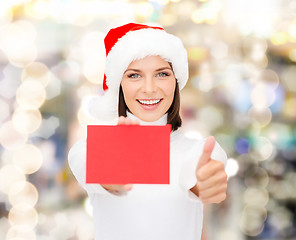 Image showing woman in santa helper hat with blank red card