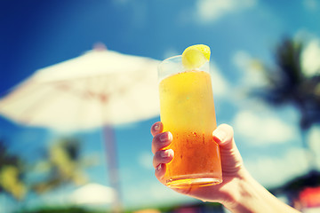 Image showing close-up of hand holding glass with cocktail