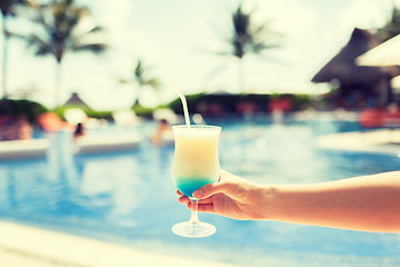 Image showing close-up of hand holding glass with cocktail