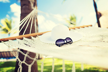 Image showing picture of hammock with white hat and sunglasses