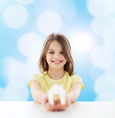 Image showing beautiful little girl holding paper house cutout