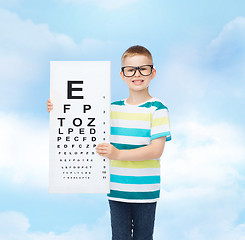 Image showing smiling boy in eyeglasses with white blank board