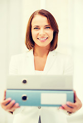 Image showing businesswoman with folders in office