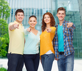 Image showing group of smiling teenagers pointing fingers on you