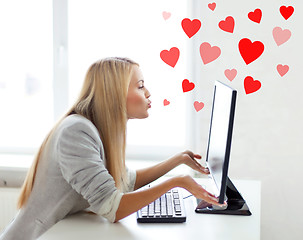 Image showing woman sending kisses with computer monitor