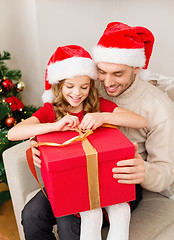 Image showing smiling father and daughter opening gift box