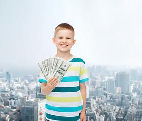 Image showing smiling boy holding dollar cash money in his hand