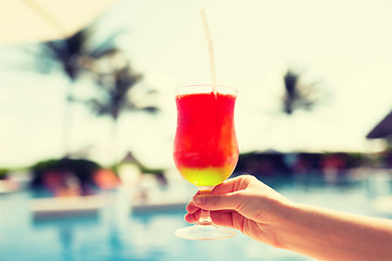 Image showing close-up of hand holding glass with cocktail