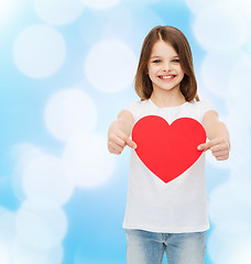 Image showing beautiful little girl sitting at table