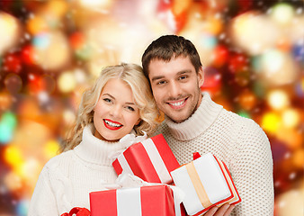 Image showing smiling man and woman with presents