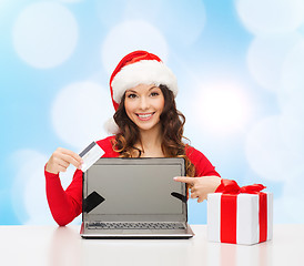 Image showing smiling woman with credit card and laptop