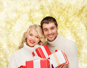 Image showing smiling man and woman with presents